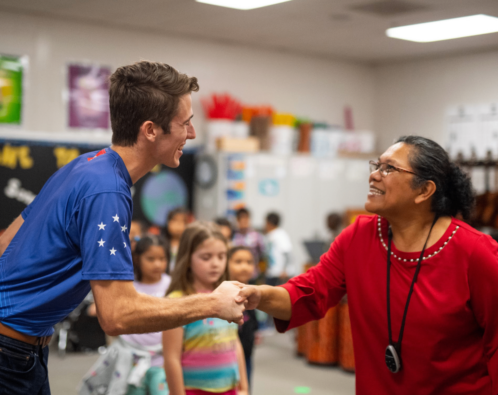 Booster ambassador greeting a teacher